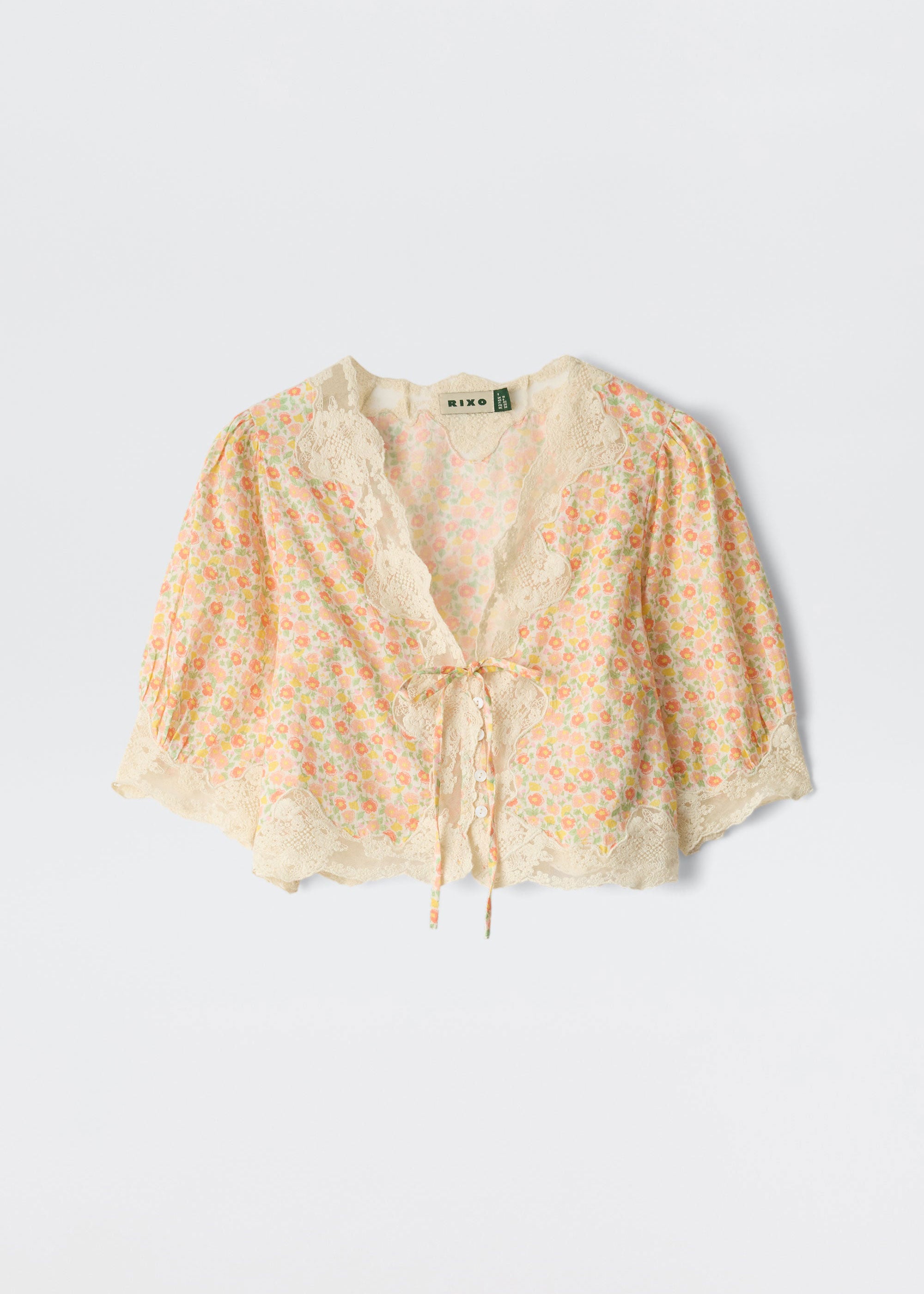 Rixo Flat-lay of the cropped top showing balloon sleeves and lace edging