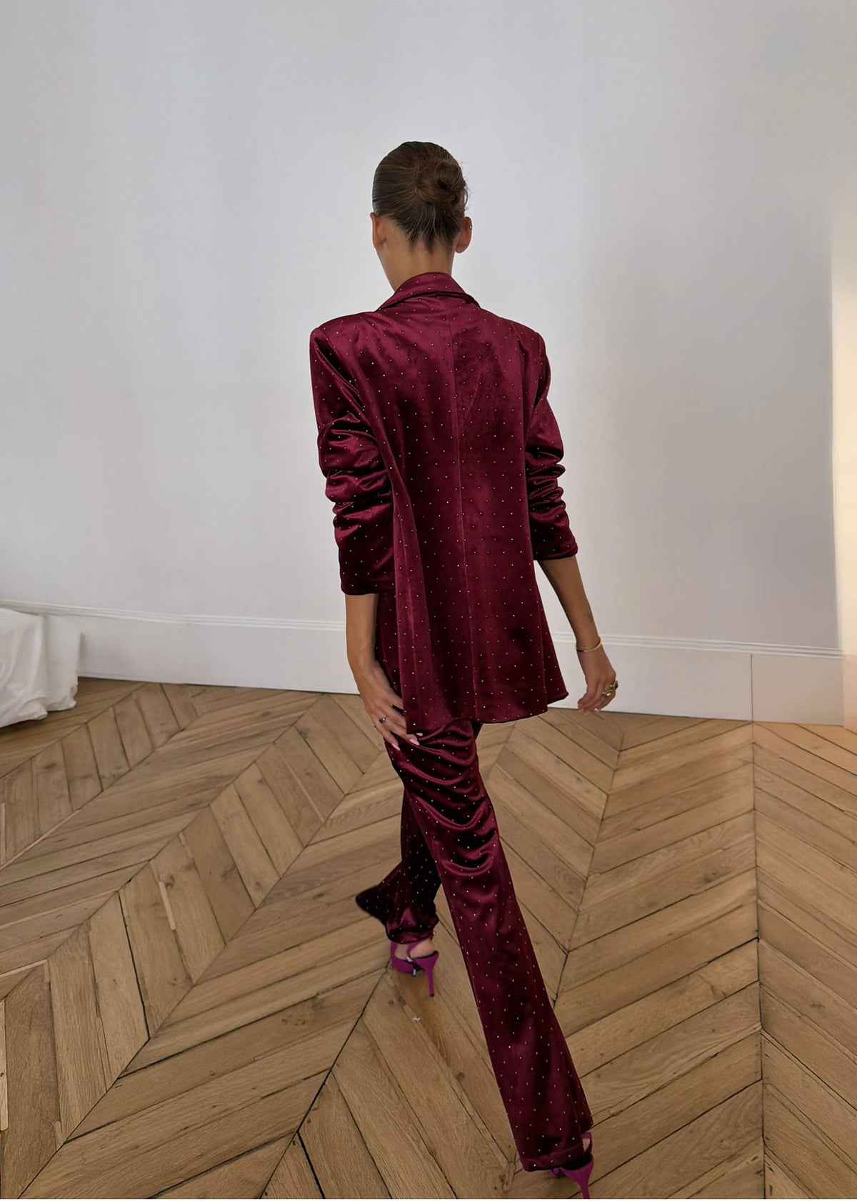 Never Fully Dressed Back view walking in crystal studded velvet flares with fuchsia pointed heels