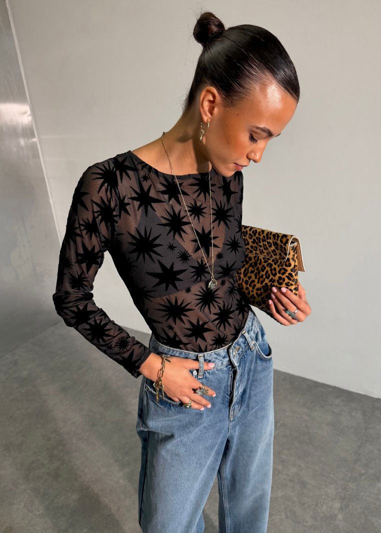 Never Fully Dressed Long sleeve fit styled with light wash jeans and a leopard clutch