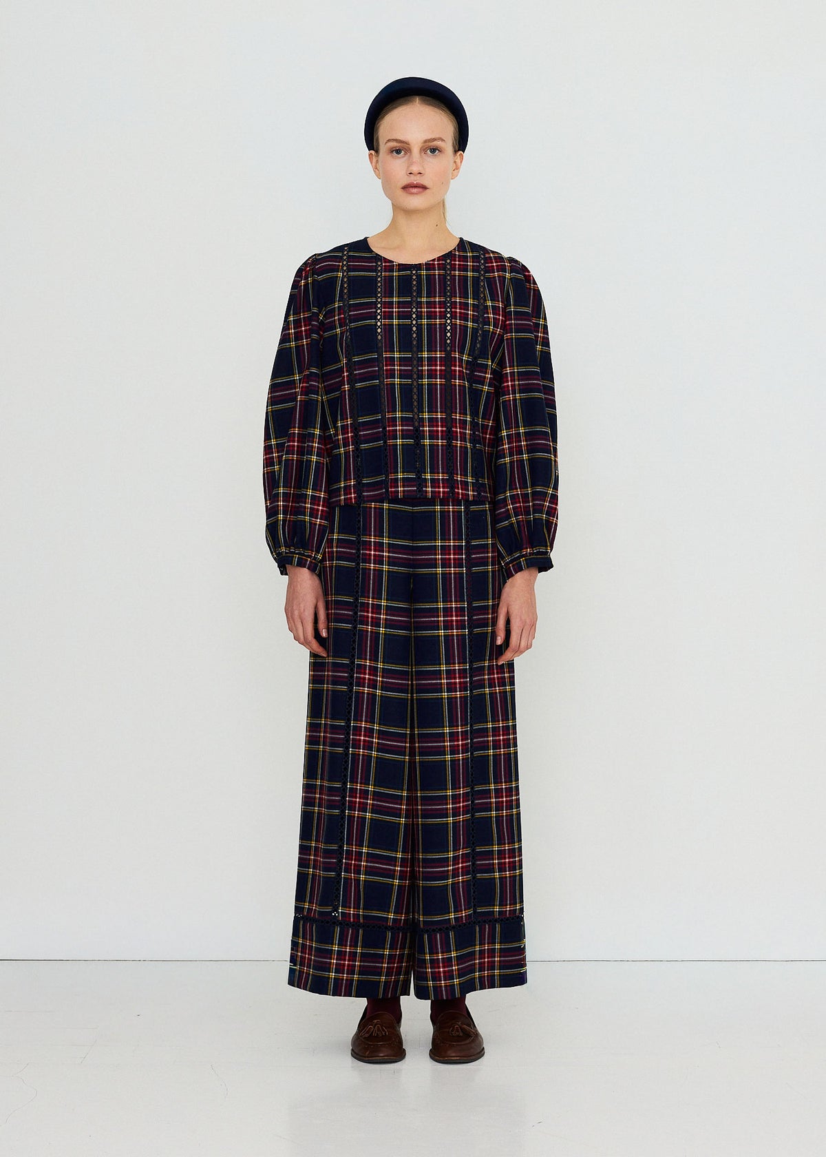 The Tiny Big Sister Full-length studio shot, cropped fit with lace trim panels and brown tasselled loafers