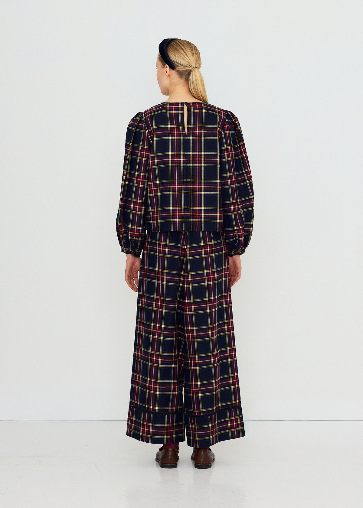 The Tiny Big Sister Back view, keyhole closure at the nape and full puff sleeves, worn with matching check wide-leg trousers