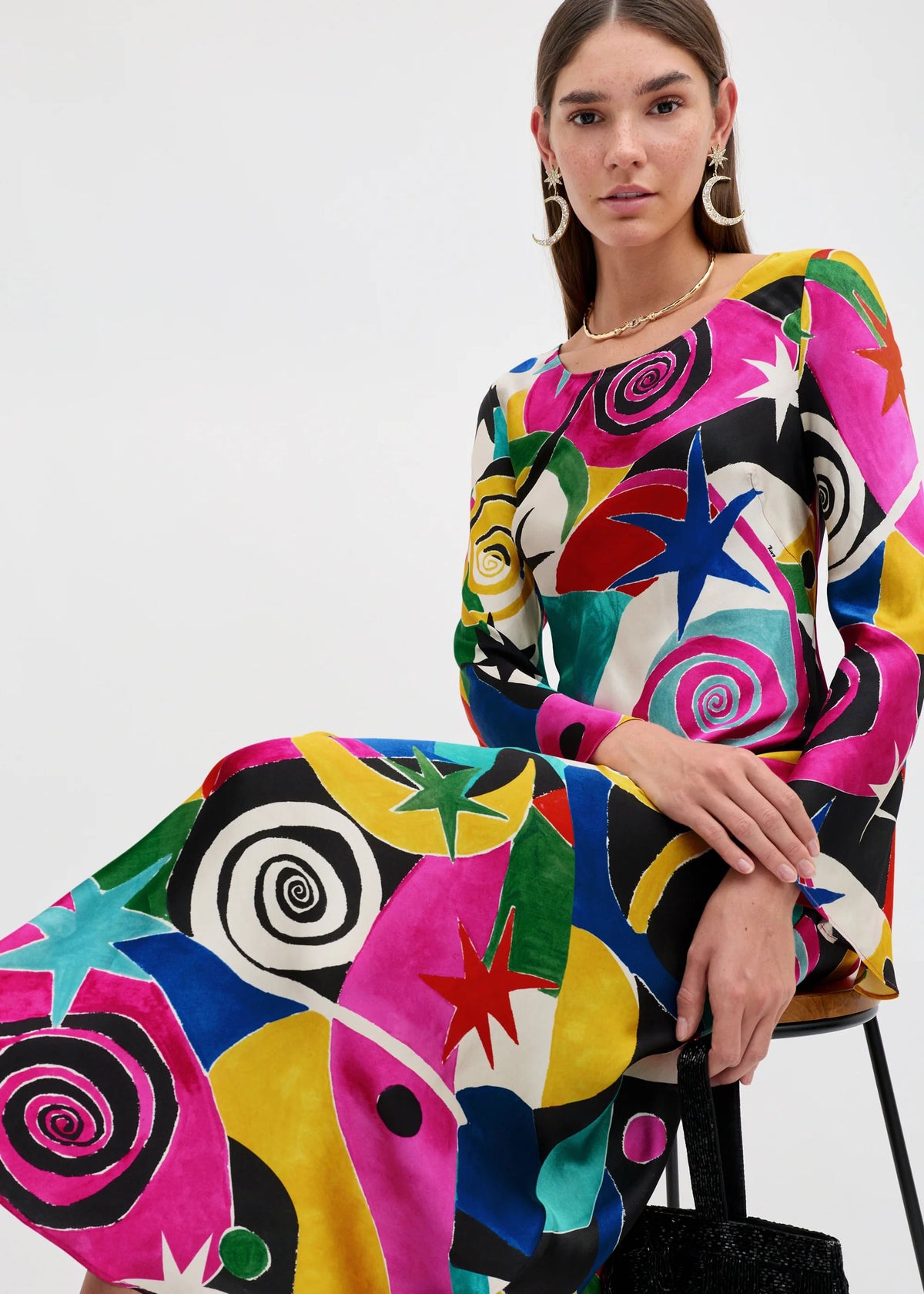 Rixo Close crop of the bold spiral and star print in pink, yellow and green on the skirt