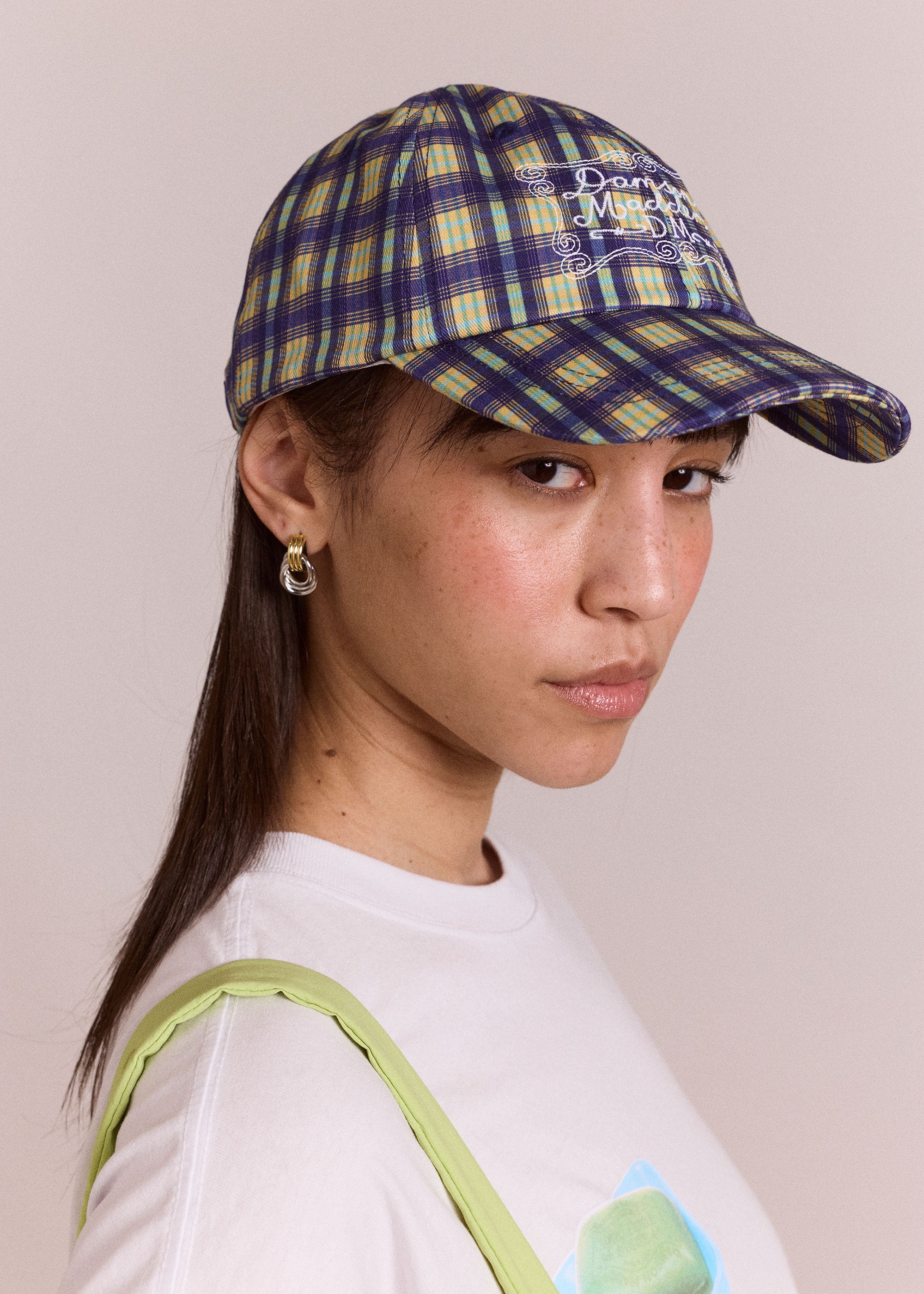 Damson Madder Damson Madder six-panel cap in tomboy check, blue with ecru swirl embroidery