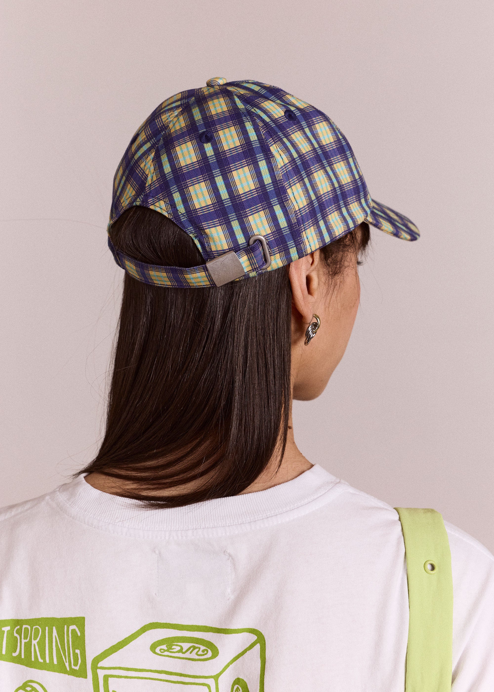 Damson Madder Front detail, ecru swirl embroidery on the blue check cap