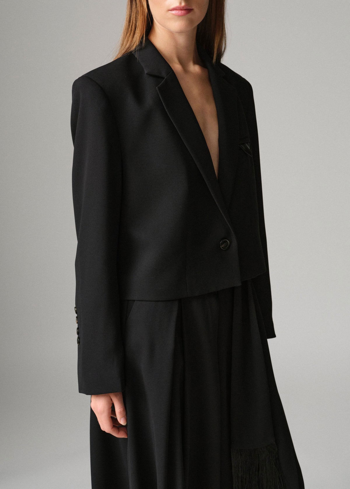 DAY Birger et Mikkelsen Deep notch lapel and leather-trimmed chest pocket, worn open over a pleated black midi skirt