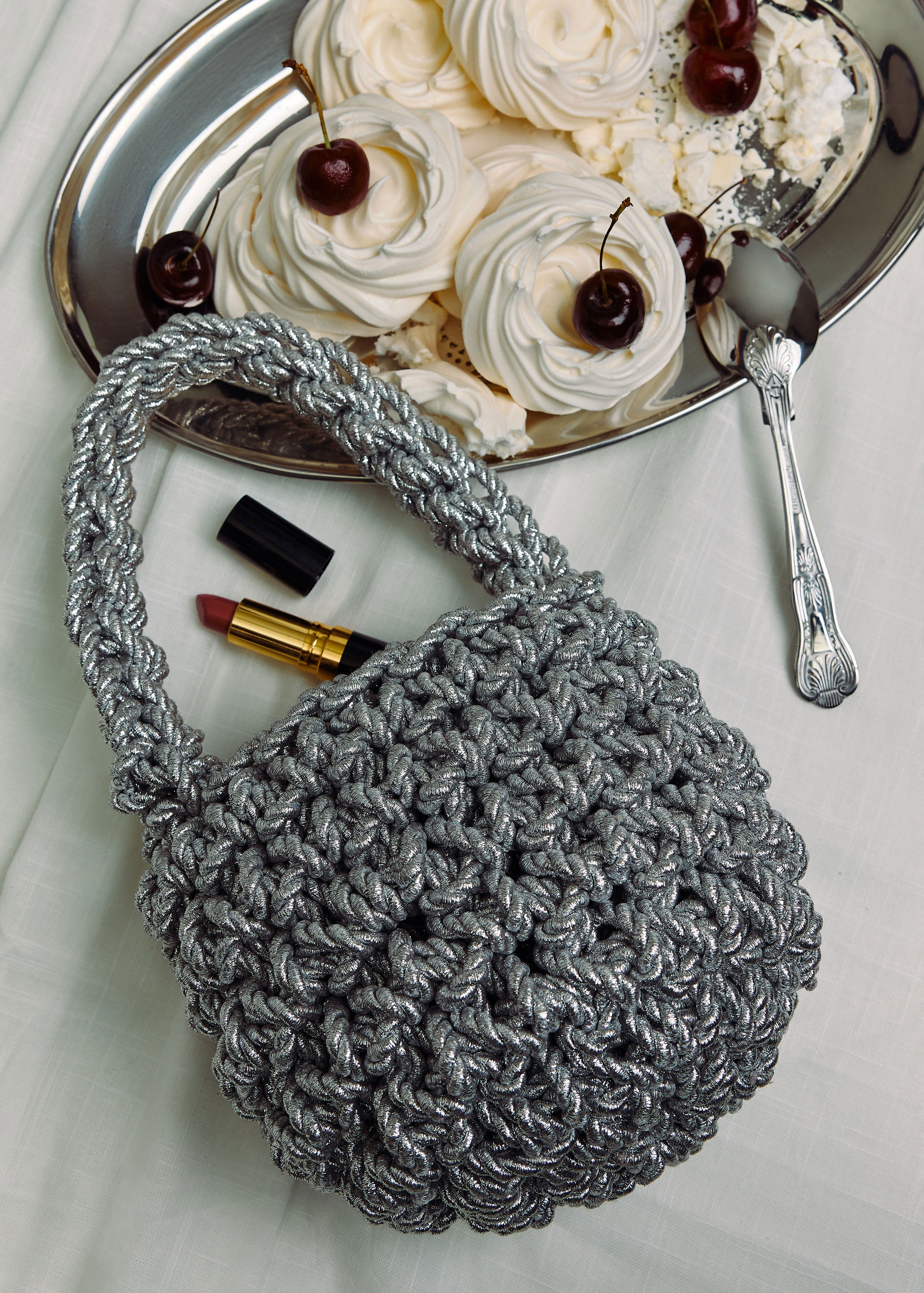 Isla De Gar Still life beside meringues and red lipstick on a silver tray