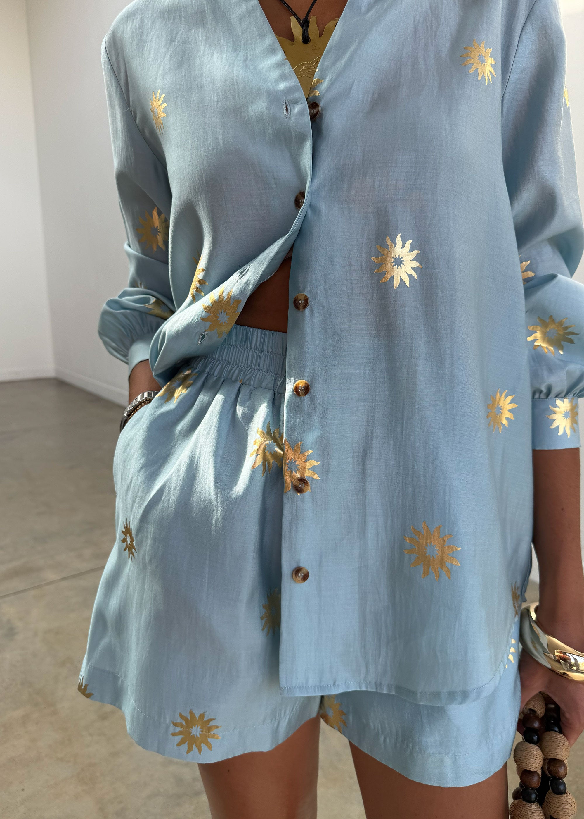 Never Fully Dressed Ice Blue Sun Miley Shirt