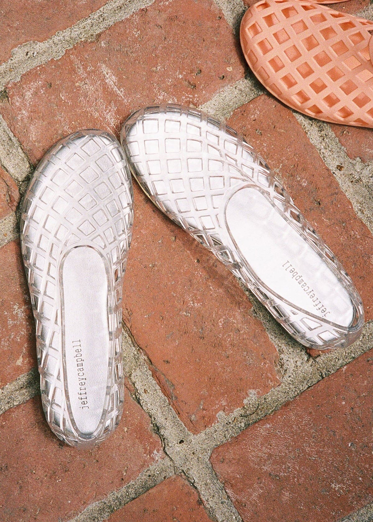 Jeffrey Campbell Styled on a terracotta brick patio with an orange jelly flat alongside