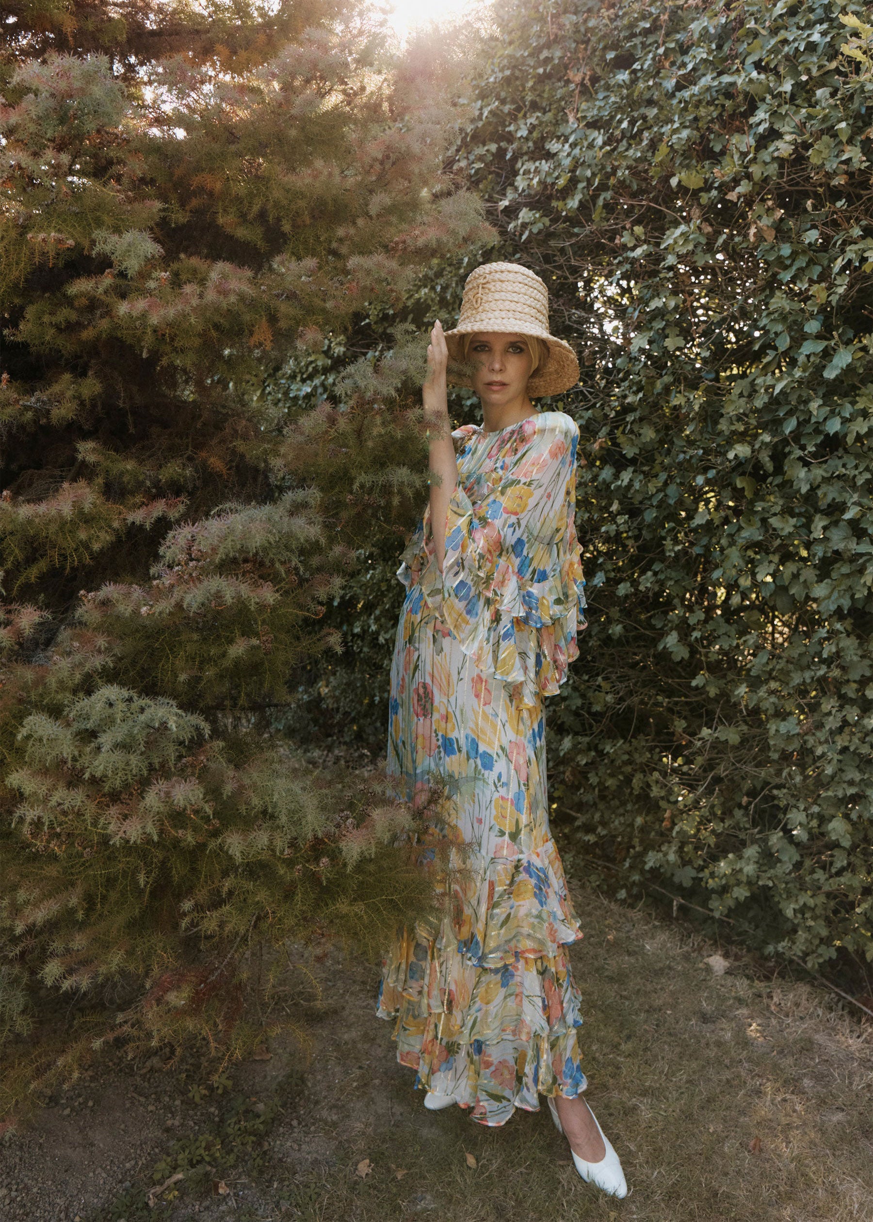 Queens of Archive Outdoor styling shot with a wide-brim straw hat against late summer foliage