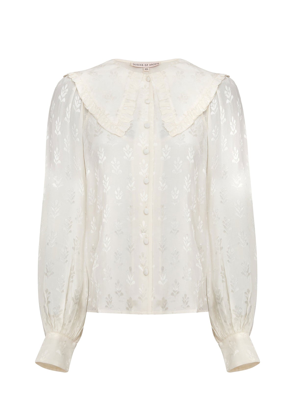 Queens of Archive Front on white, covered button placket, ruffle-edged collar and buttoned cuffs