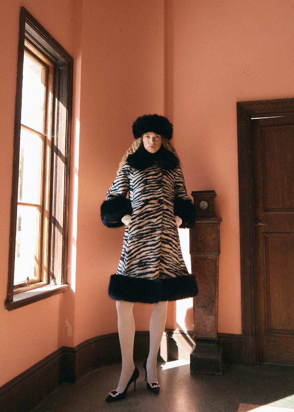 Queens of Archive Wider view with a black faux fur hat and white tights, flared line and deep fur cuffs