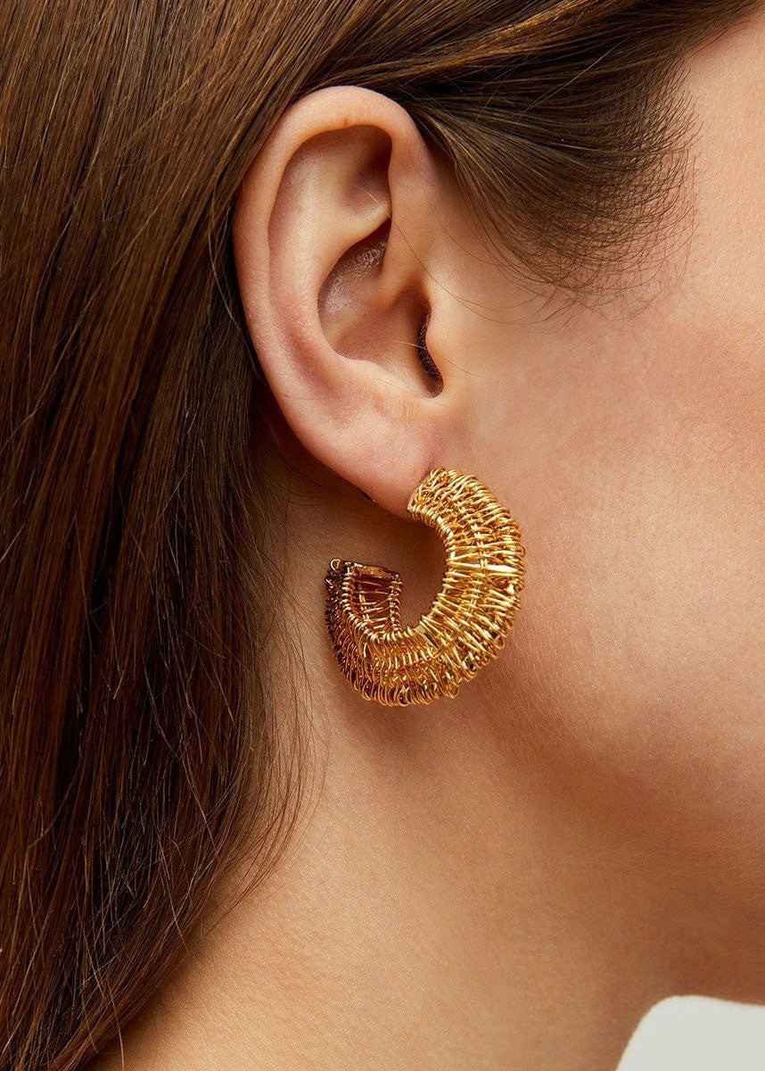 Gas Bijoux Worn shot showing the petite Filea hoops on-ear in summer light