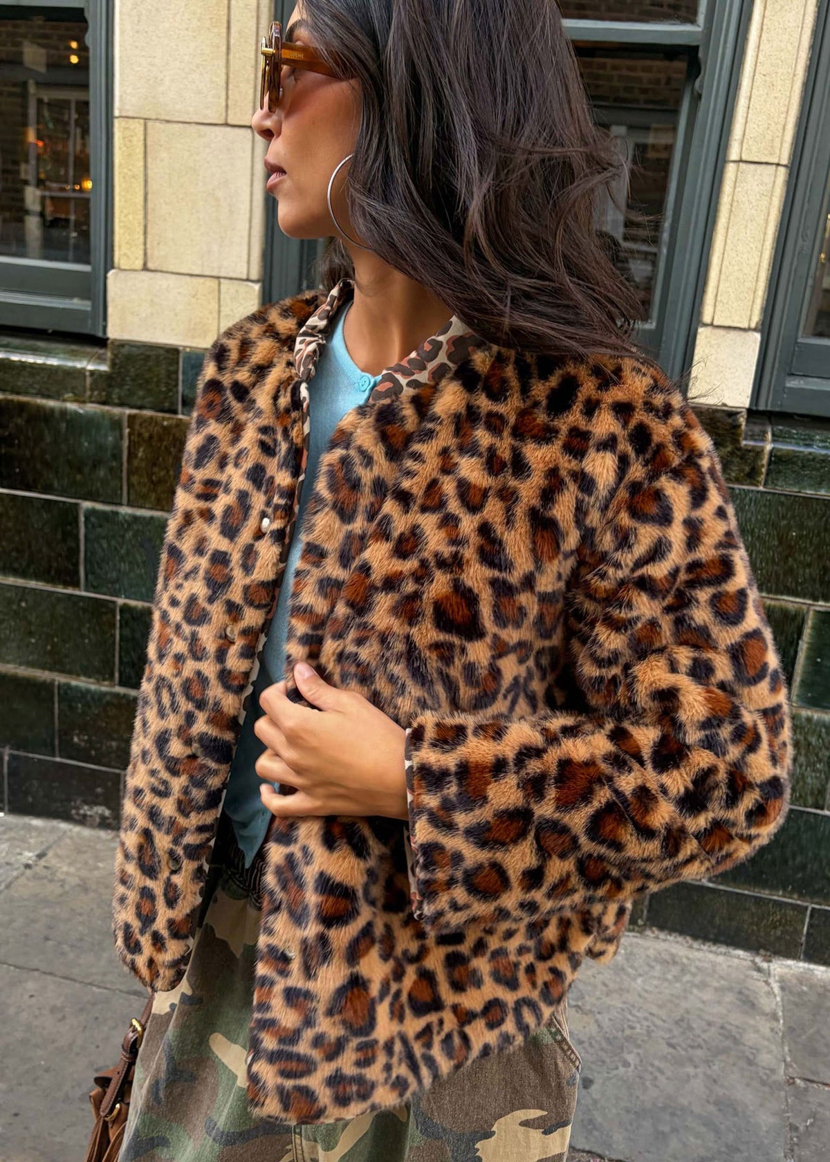 Never Fully Dressed Leopard faux fur reverse side worn open over a pale blue top