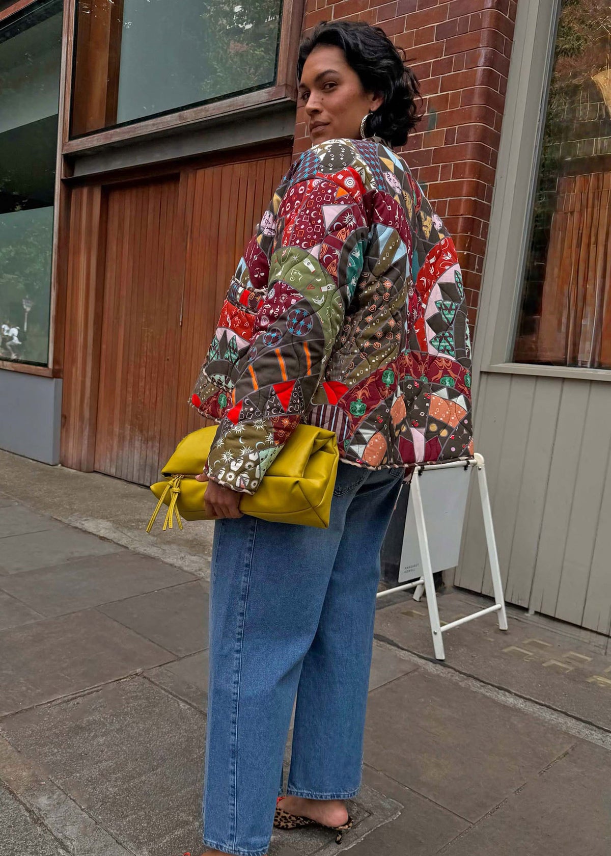 Never Fully Dressed Over the shoulder glance at the back panel with light wash jeans