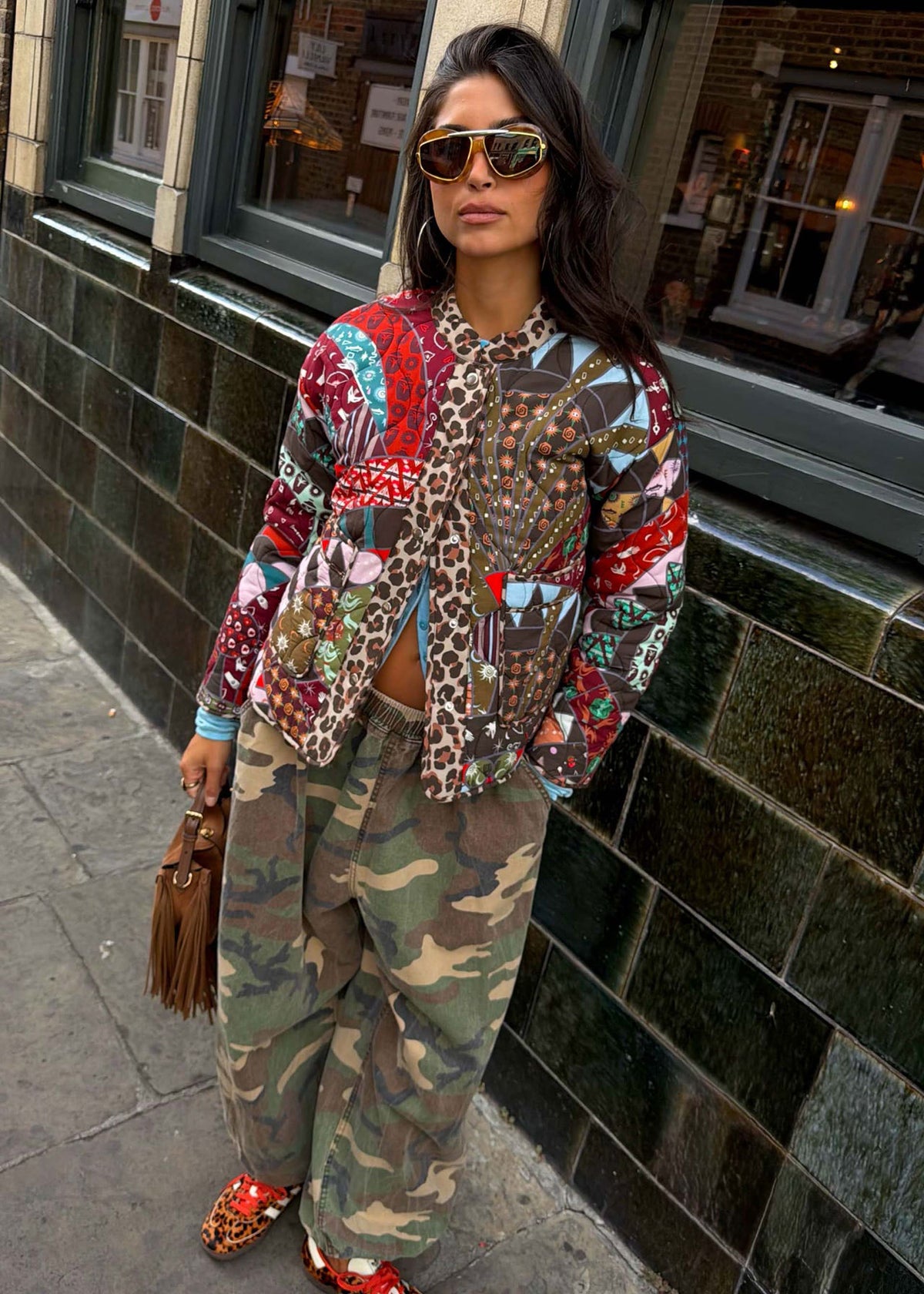 Never Fully Dressed Looking to camera in aviators with leopard collar peeking through the patchwork