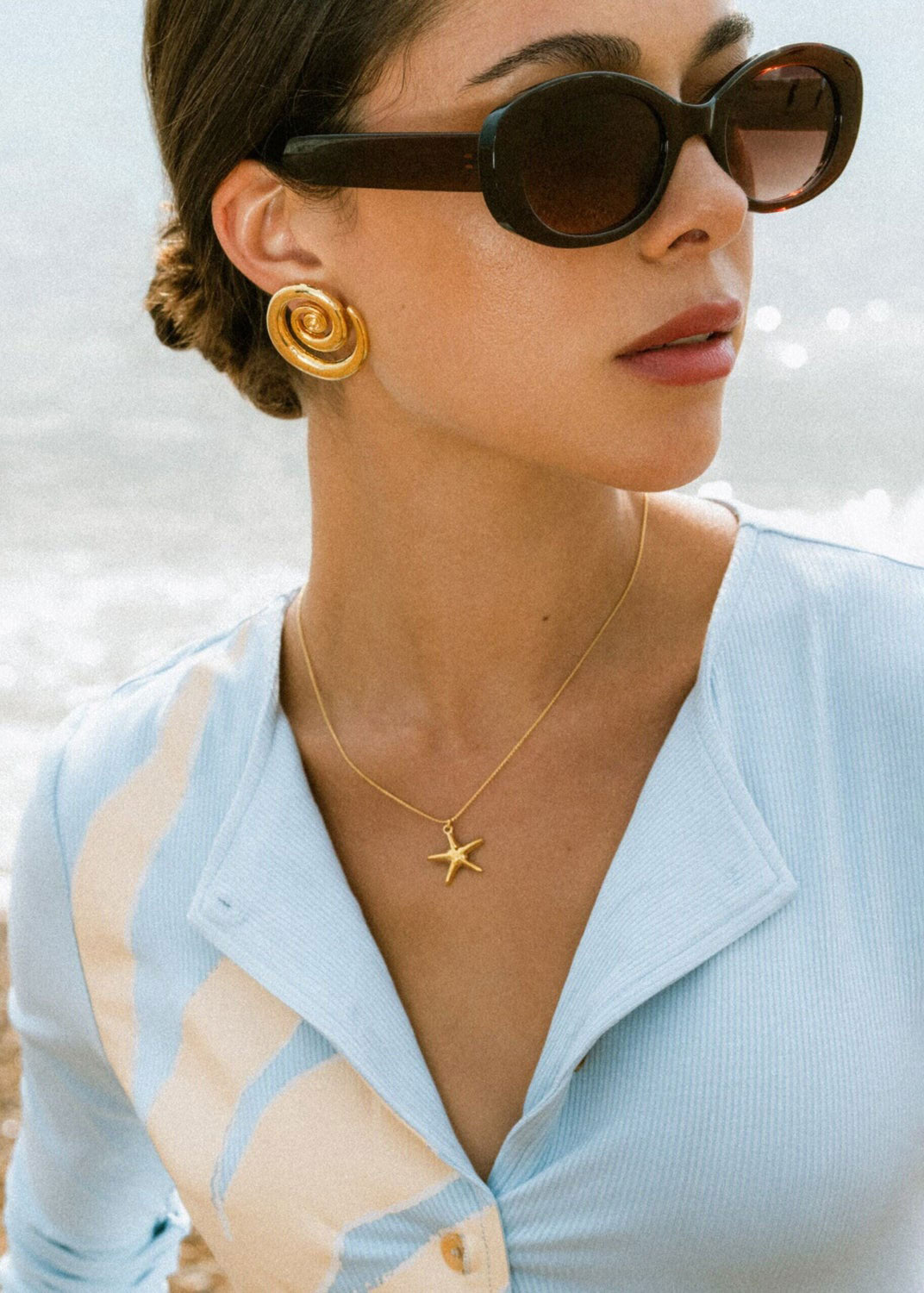 Orelia On-neck styling shot showing the pendant at the throat