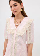Worn close-up with a pale pink lace scallop-collar dress