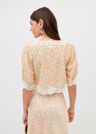 Back view showing scalloped lace hem and ditsy floral cream print
