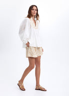 Full-length styling with the matching white Flakes embroidered tunic top