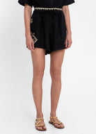 Greek Archaic Kori Lefkada drawstring shorts in black linen with gold zigzag waistband