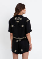 Back view, scattered gold star motifs and zigzag pyramid hem trim