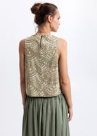 Three-quarter back view, gold fan embroidery across the yoke and lower hem