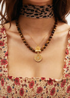 Styled with a leopard silk neckerchief and shirred floral top