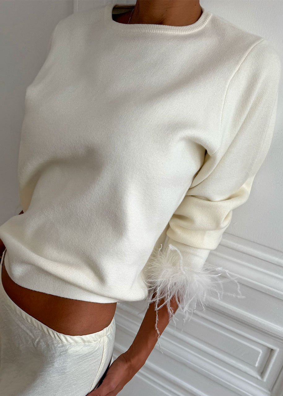 Never Fully Dressed Close up of ribbed crew neck and pale feather trim
