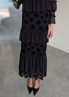 Close up of tiered ruffle skirt with star devore hem