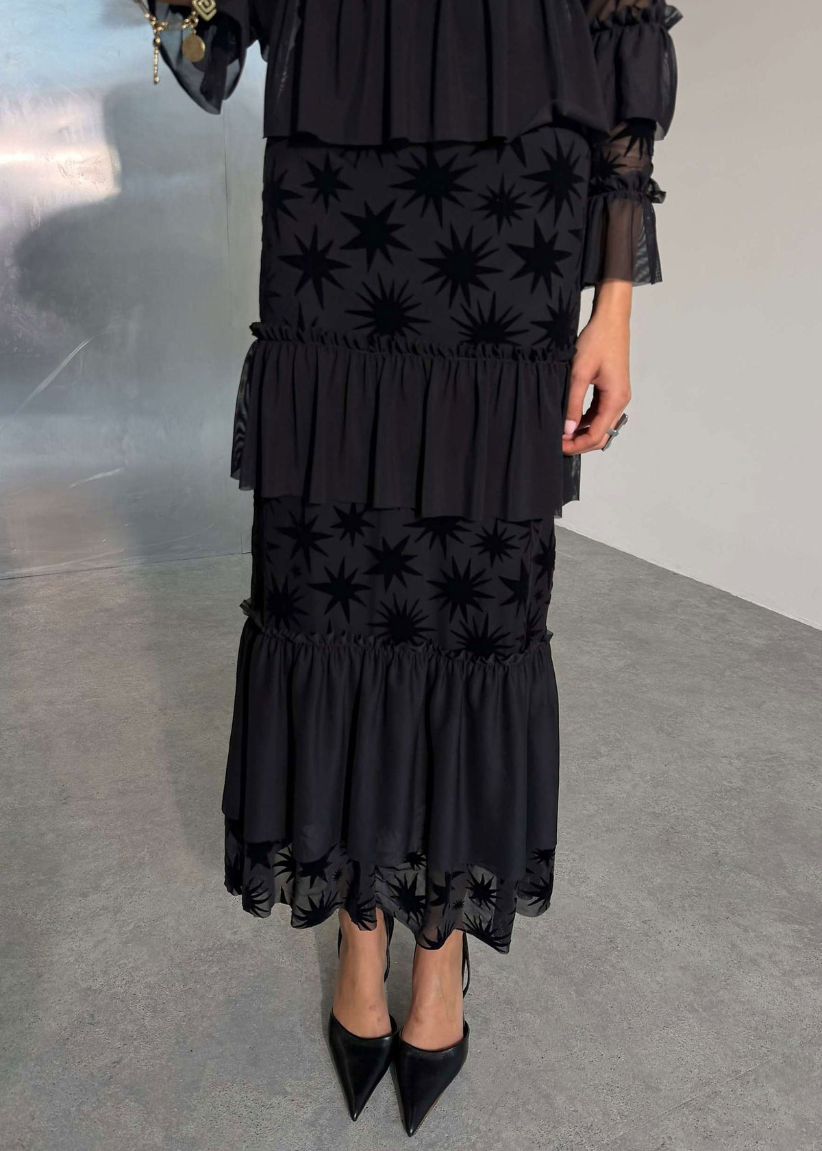 Never Fully Dressed Close up of tiered ruffle skirt with star devore hem