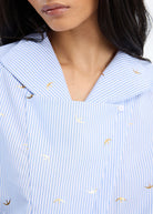 Close-up of the bird motif print and draped collar
