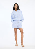 Styled with tailored shorts, full-length front view