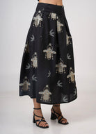 Side view showing box pleats and full midi length