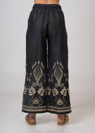 Back view of the wide-leg trousers with gold urn and lotus hem embroidery