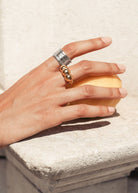 On-hand styling shot of the wide silver cuff worn