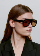 Worn in profile by a model with the lenses on