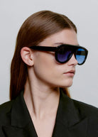 Worn in profile by a model with the lenses on