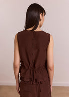 Back view, chocolate panel blouse with sheer overlay