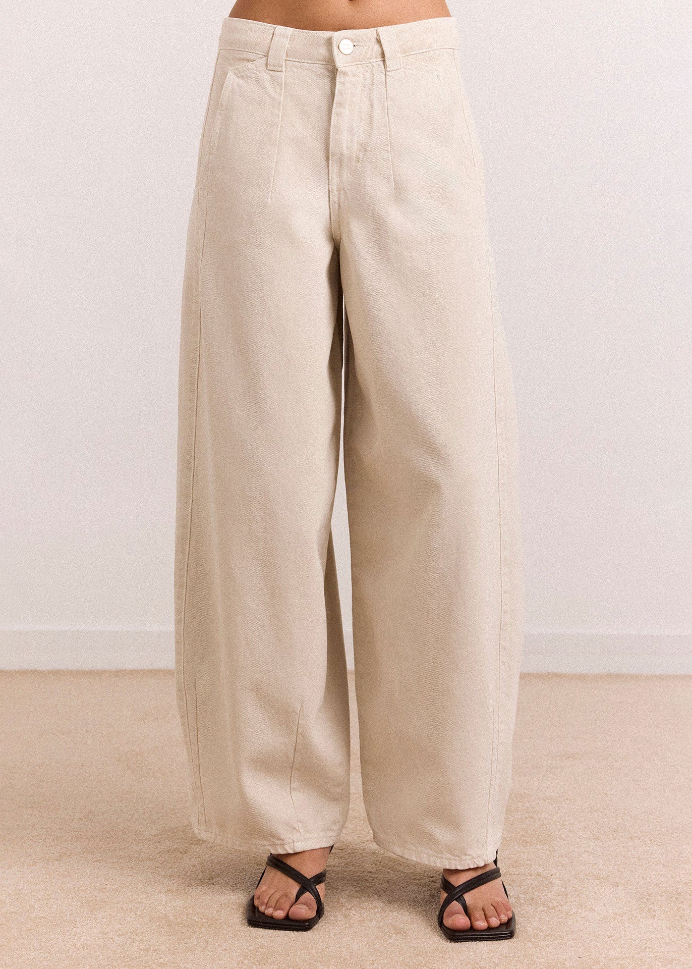Damson Madder Side profile, curved barrel-leg silhouette in soft cream denim