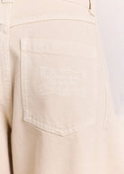 Tonal crest detail stitched onto the right back pocket