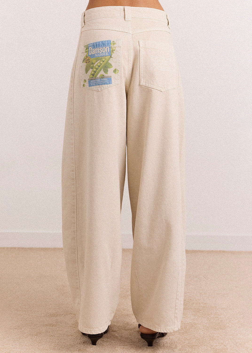 Damson Madder Hem detail showing the tapered ankle over black strappy sandals