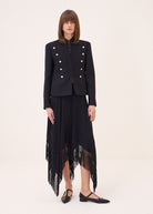 Full length front view, cropped fit styled with a fringed black skirt