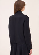 Back view, plain stand collar and cropped hem with braided cuff stripes