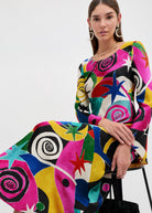 Close crop of the bold spiral and star print in pink, yellow and green on the skirt
