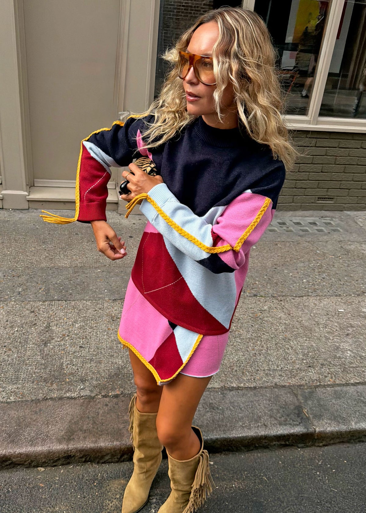 Never Fully Dressed Mid movement view with the asymmetric hem and tasselled cuff