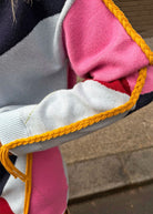Close crop of the golden plait stitched along the shoulder seam