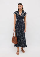 Front three-quarter view styled with a brown woven leather tote
