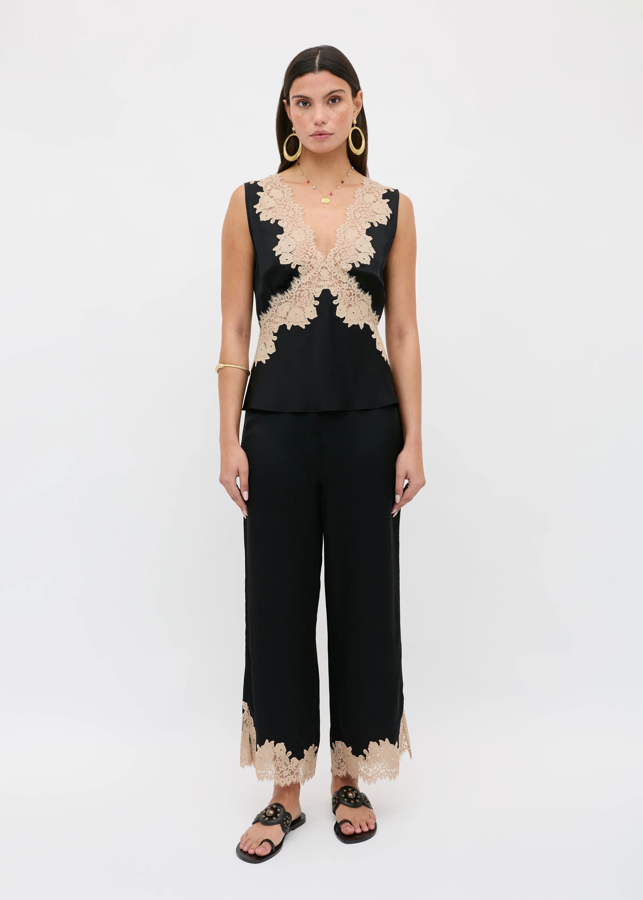 Rixo Full body styled with black satin trousers and gold-studded slides