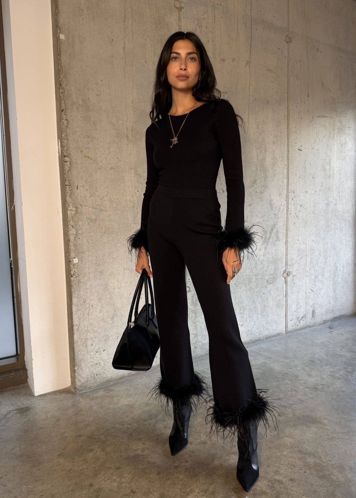 Never Fully Dressed Matching fitted top with black tote and heeled ankle boots against concrete