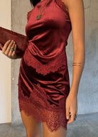 Red velvet top and skirt close up, lace trim sitting across the hip